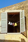 Window with clothing line & wood shutters