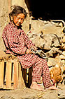 Young girl sitting near chicken