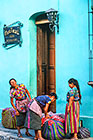 Indian women in front of houses in street