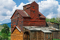 Old red silo-barn & clouds
