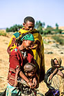 man with colorful blanket, girl & little girl