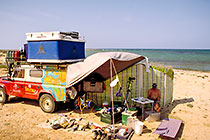 landy (RL) with things out + Paul reading at campsite + beach & sea