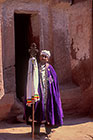 priest holding old cross of Lalibella in front church door