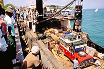crane unloading landy from ship to Zanzibar harbor