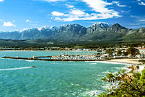 sea + Gordon's Bay harbor w sail boats + Hottentots-Holand mts w snow