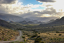 Mountains and hills with road and clouds