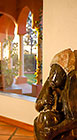 african stone sculpture of woman stirring