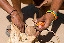bushman showing stuff in bag