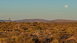 full moon over karoo landscape at sunset