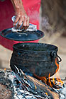 old busman woman preparing nama melon soup in open kitchen