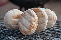 bread rolls cooking on open fire