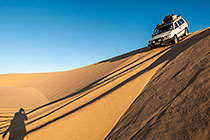 Land Cruiser driving down sand dunes