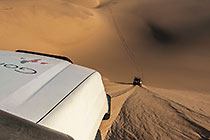 Land Cruiser driving down sand dunes