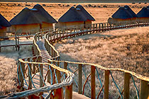 Sossus Dune Lodge bungalows at sunset