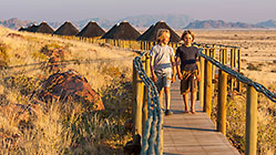 Sossus Dune Lodge bungalows at sunset