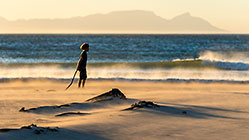boy James playing on windy beach