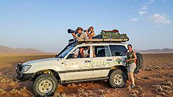 Lisa | James & Paul taking photos from roof of land cruiser