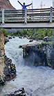 Lisa on bridge over river flowing in canyon