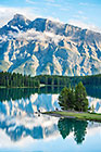 mountains & pine tree forest reflection in lake