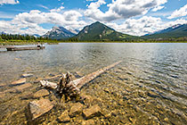 Lisa on ponton | pine tree log in water, lake & mountains