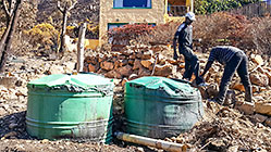 Cocagne - repairing garden fence burnt by fire