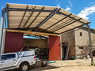 Paul fixing roof sheets above solar & workshop toilet