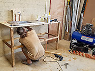 Paul connecting plumbing under workshop sink