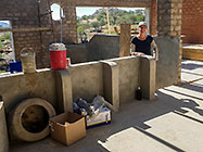 Lisa inspecting house plastered brick walls