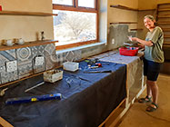 Lisa tiling over house kitchen countertops