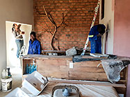 Lisa, Rodney & Sedney painting walls in house master bedroom-bathroom