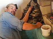 Paul building mini rock waterfall over house master bathroom bathtub