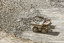 front loader loading rocks into 90 T trucks in pit
