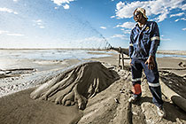 field assistant nnear cyclone sprayer on tailings