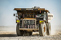 90 T truck driving on top of waste pile