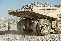 worker | 90 T truck offloading rocks on top of waste pile