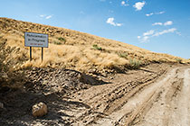 rehabilitated slopes with top soil showing growth of grass and local bushes