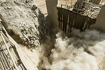 90 T truck offloading graded rocks into crusher
