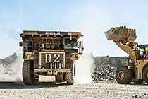 front loader loading graded rocks into 90 T truck to be offloaded at crusher