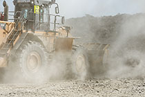 front loader loading graded rocks to be offloaded at crusher