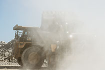 front loader loading graded rocks into 90 T truck to be offloaded at crusher