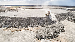 LDV & 90 T truck offloading rocks on top of waste pile