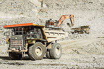 excavator loading 90 T trucks in pit