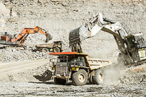 excavators loading 90 T trucks in pit