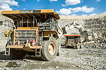 excavator loading 90 T trucks in pit