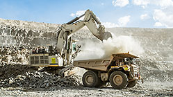 excavator loading 90 T truck in pit