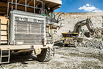 excavator loading 90 T trucks in pit