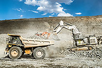 excavators loading 90 T truck in pit