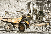 excavator loading 90 T trucks in pit