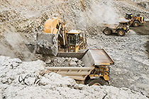 excavator & front loader loading 90 T trucks in pit