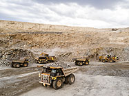 excavator & front loader loading 90 T trucks in pit